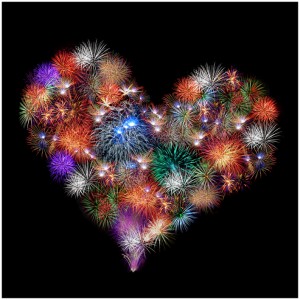 a group of exploding fireworks shaped like a heart in the night sky
